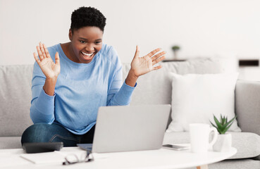 Black woman having video call using laptop and talking