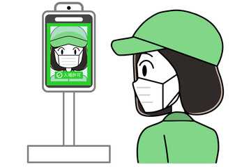 タブレット体温計で体温を測る女性作業員