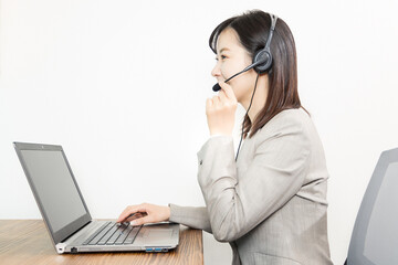 Woman wearing a headset and having a web conference