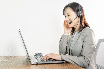 Woman wearing a headset and having a web conference