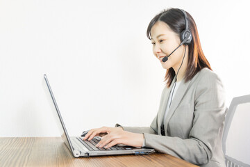 Woman wearing a headset and having a web conference