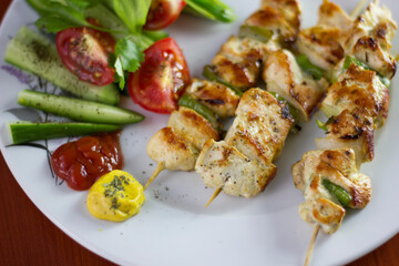 Chicken shish kebab, grilled chicken with greens and tomato