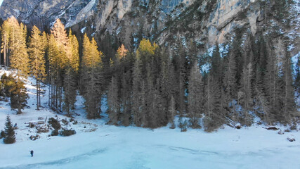 Braies Lake blotted in winter, aerial view from drone, Italian Alps