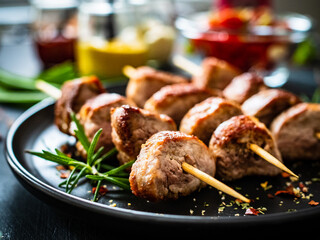 Skewers - grilled pork meat with vegetables on wooden background table
