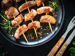 Skewers - grilled pork meat with vegetables on wooden background table
