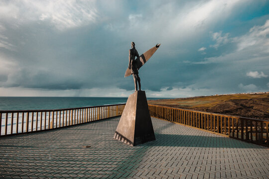 Statue of a surfer in the beach of Ribeira d&rsquo;Ilhas World Surf Reserve. Ericeira in Portugal