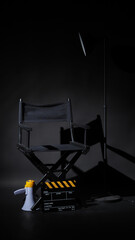 Black director chair and Clapper board or movie Clapperboard with megaphone on black background.use in video production or film cinema industry