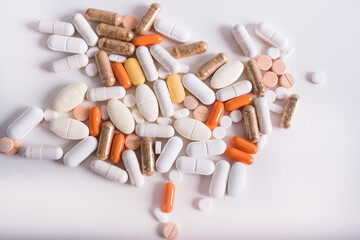 Different kind of pills and capsules on white background. Pharmaceutical packaging with drugs and pills. Concept of medicine. 