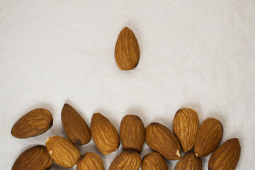 almonds on white isolated background. one main nut over all with copy space