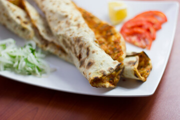 Traditional Turkish pizza (lahmacun) in a white plate