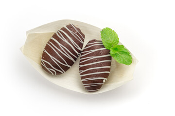 Chocolate covered dates sweet arab candies for dessert isolated on white, top view