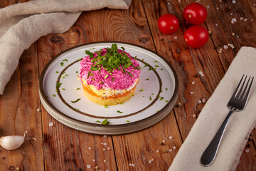 Salad with herring and beets, Russian cuisine, wooden background