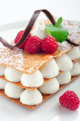 raspberry mille feuille dessert on a white plate, close up