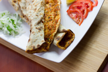 Traditional Turkish pizza (lahmacun) in a white plate