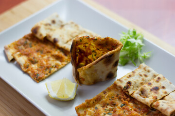 Traditional Turkish pizza (lahmacun) in a white plate