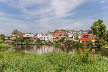 Fototapeta na wymiar Houses at the river Vlist in Haastrecht, Netherlands