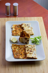 Traditional Turkish pizza (lahmacun) in a white plate