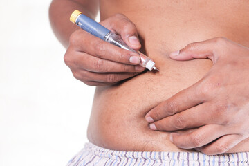young man hand using insulin pen isolated on white 