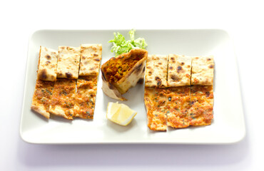 Traditional Turkish pizza (lahmacun) in a white plate