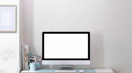 Mockup blank screen computer monitor on wooden table in modern room with brick wall.