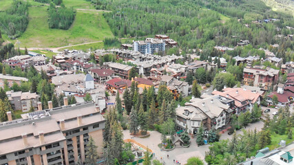 Fototapeta na wymiar Vail city center and surrounding mountains, Colorado. Aerial view from drone in summer season