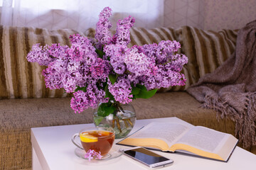 Cozy home still life - a bouquet of lilacs in a glass vase.
Home related concept
