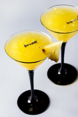 Glasses of Frozen Pineapple Daiquiri Cocktail with Ice Blue Background Yellow Alcoholic Beverage Vertical