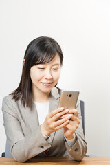 Woman uses a smartphone at work