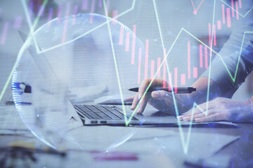 Multi exposure of woman hands typing on computer and financial chart hologram drawing. Stock market analysis concept.