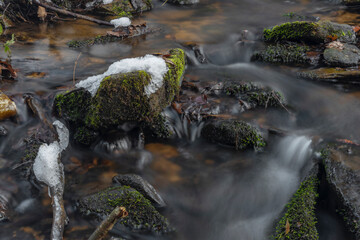 Kokotinsky dick creek with green moss stone in winter cold day