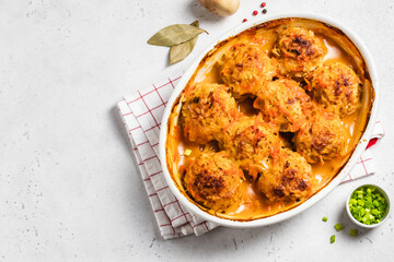 Baked meatballs with garlic tomato sauce in a baking dish. Space for text, top view.