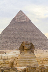 Fototapeta na wymiar Sphinx sculpture and the Cheops pyramid in Giza, Egypt