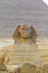 Sphinx sculpture and the Cheops pyramid in Giza, Egypt