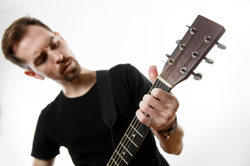 Guitarist playing a chord on a guitar fretboard close up.
