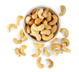 Top view of Roasted Cashew nuts in white cup isolated on white background with clipping path