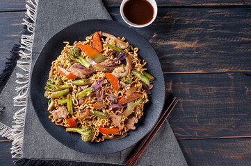 .Yakisoba, famous Japanese fried noodles, with meat and vegetables. Top view. Copy space