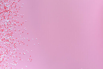 Small red, pink and white hearts on a trendy pink background. Happy Valentine's Day, Mother's Day, March 8, World Women's Day holiday card concept. Flat lay.