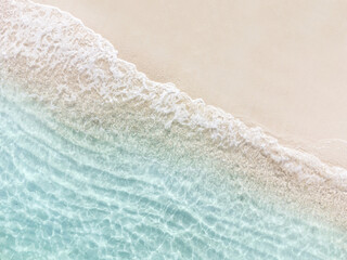 Aerial top view of beautiful tropical white sand beach with wave foam and transparent sea, Summer vacation and Travel background with copy space, Top view from drone - obrazy, fototapety, plakaty