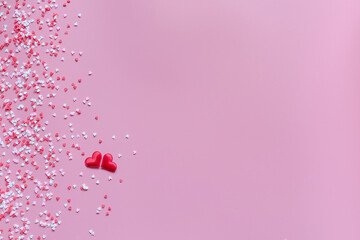 Small red, pink and white hearts on a trendy pink background. Happy Valentine's Day, Mother's Day, March 8, World Women's Day holiday card concept. Flat lay.