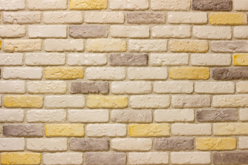 Fototapeta premium An example of facing an internal partition in a room of a house with decorative gypsum bricks with tiles in the shape of an antique wall, powder grout and colorless matte varnish