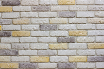 An example of facing an internal partition in a room of a house with decorative gypsum bricks with tiles in the shape of an antique wall, powder grout and colorless matte varnish