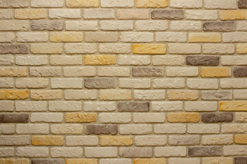 Wall with decorative plaster facing bricks following the example of antique tiles in white, yellow and gray. Original background, pattern for graphic works and design