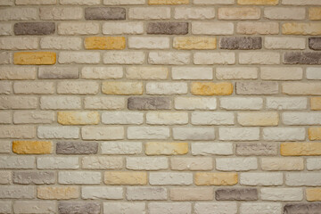 An example of facing an internal partition in a room of a house with decorative gypsum bricks with tiles in the shape of an antique wall, powder grout and colorless matte varnish