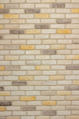 An example of facing an internal partition in a room of a house with decorative gypsum bricks with tiles in the shape of an antique wall, powder grout and colorless matte varnish