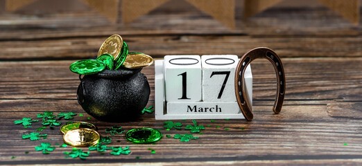 Vintage white calendar for St. Patrick's Day, March 17, with a lucky horseshoe and a pot of gold on...