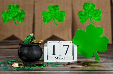 Vintage white calendar for St. Patrick's Day, March 17, with a lucky horseshoe and a pot of gold on...