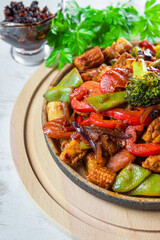  Stewed vegetables with meat on a plate close up vertical photo