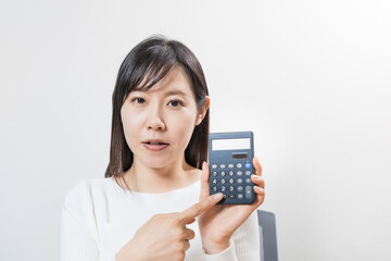 Woman pointing at a calculator