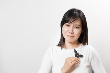 Woman with ninja star (throwing knife) © Ken Tyler