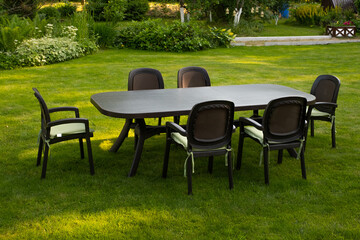 Table and chairs in garden. Selective focus
